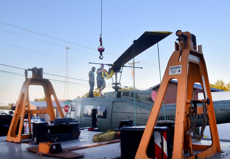 Crews from Midwest Aerospace and Dave's Crane & Wrecker Service prepare a Huey helicopter memorial on Sept. 30 in Baxter.