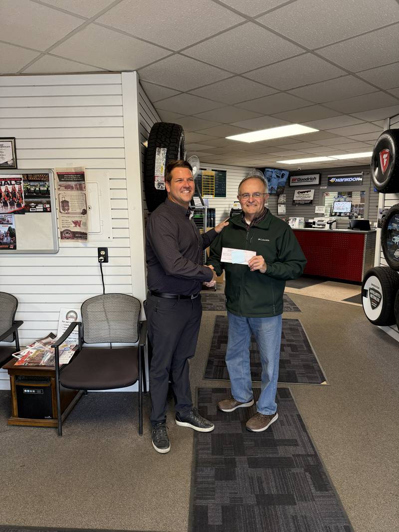 Left, Coridan McGinley of Cappy's Tire and Auto Service, presents a check to Ron Ehresman with Jasper County Historical Society.