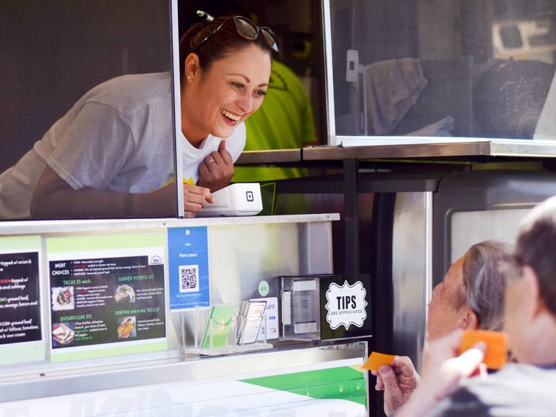 Customers order from the Kiki's food truck in May outside of Berg Middle School in Newton.