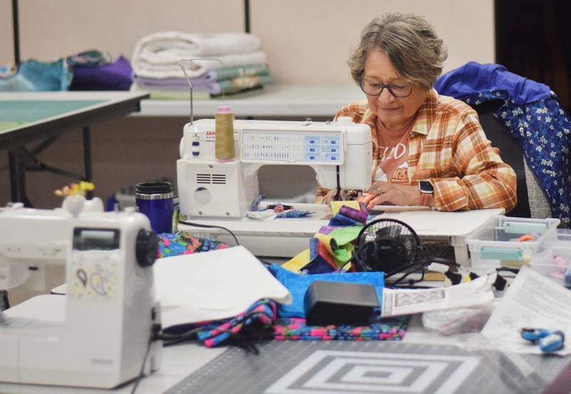 Members of the 1/4-Inch Quilters prepare for the upcoming quilt auction that will be held 6 p.m. Nov. 10, 2023 at the DMACC Newton Campus. The auction is a fundraising for the Salvation Army.