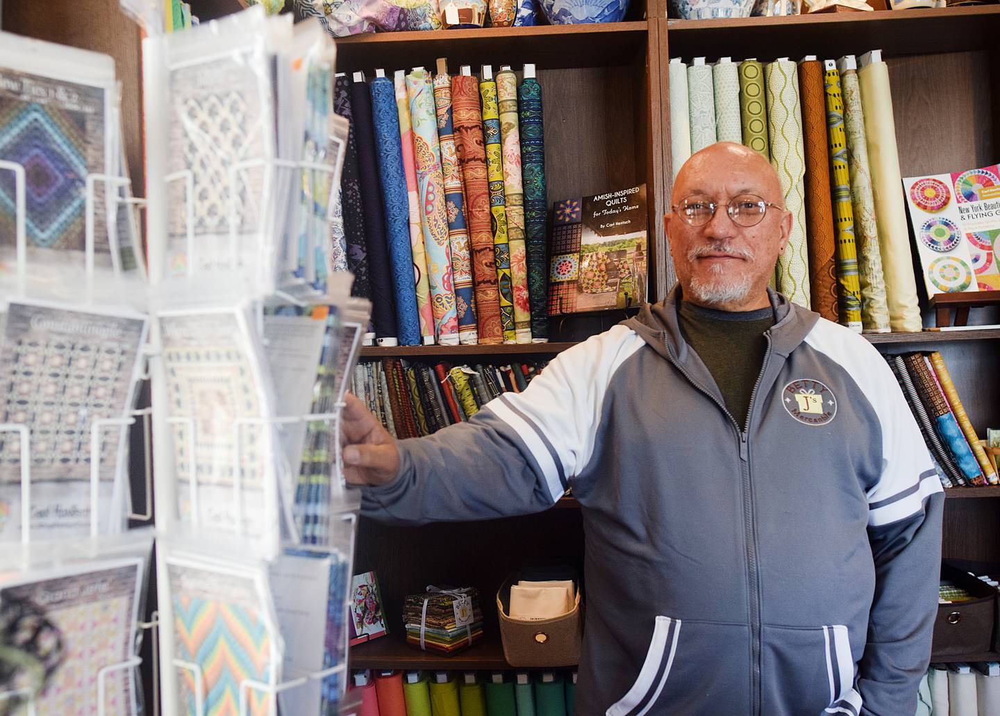 Carl Hentsch shows off fabrics and patterns available at Betty J's Mercantile in Newton.