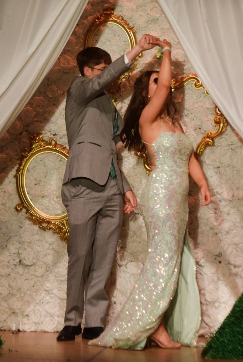 High schoolers pose for photographs before and after entering the auditorium for prom night on Aug. 15 at the Newton High School. Cardinals met for photos at a heart-shaped display on the stage before enjoying the festivities of prom night.