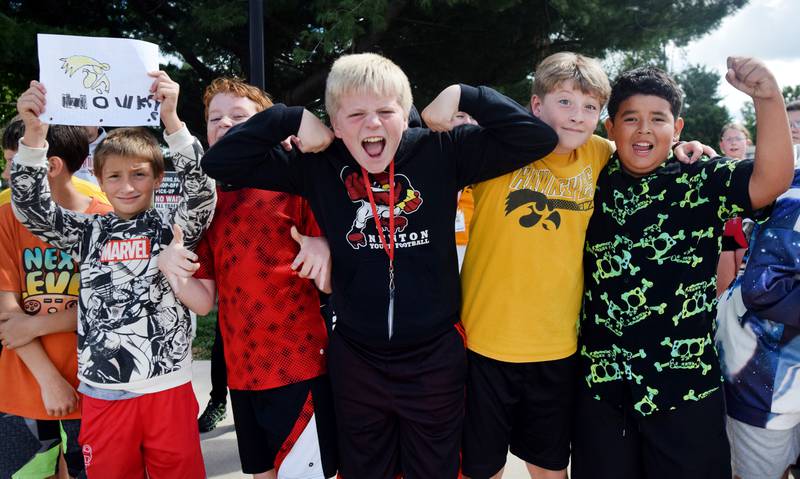 Students wearing Cyclone and Hawkeye apparel pose for pictures on Sept. 4 outside Berg Middle School. The whole study body was invited to welcome RVTV to town.