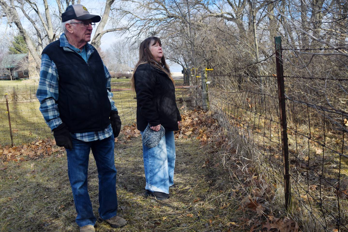 Gary and Mary Adams, of rural Colfax, walk along the fence line of their property, which will be moved to make way for the construction of a Level B road that was left unmaintained for several decades. Supervisors argue Jasper County could be liable for failure to maintain if the road is not extended to grant access to another property owner's 20-acre parcel.