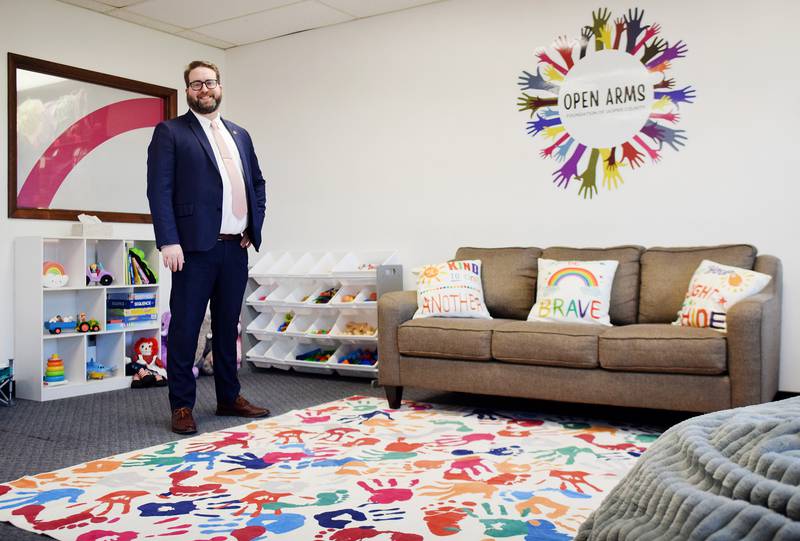Nicholas Pietrack, assistant county attorney and founder of the Open Arms Foundation Jasper County, shows off the family room of the newly established nonprofit, which aims to improve the lives of children in foster care and those who had to be removed from families due to abuse.