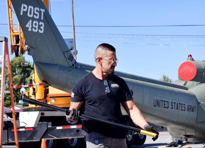 Crews from Midwest Aerospace prepare a Huey helicopter monument on Sept. 30 in Baxter.