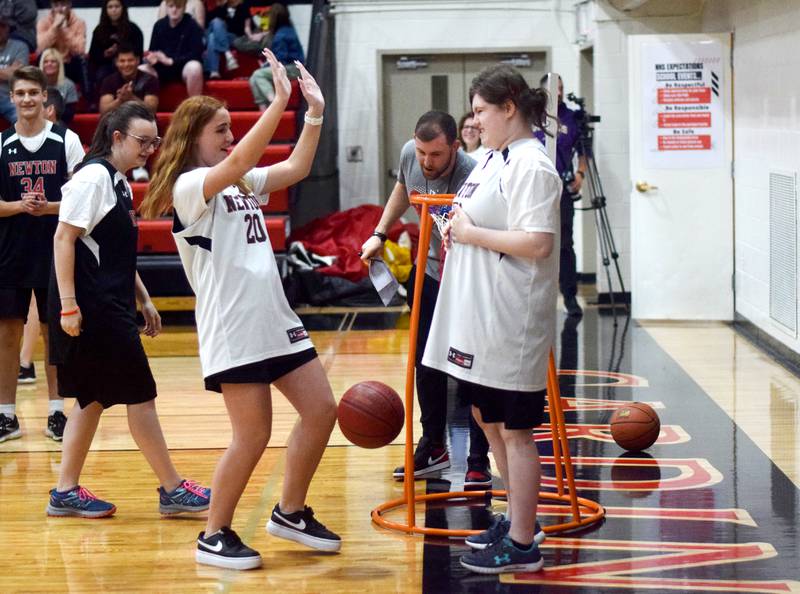 Kaylee Spidell receives a high-five from a teammate during The Big Game on April 19 at Newton High School.