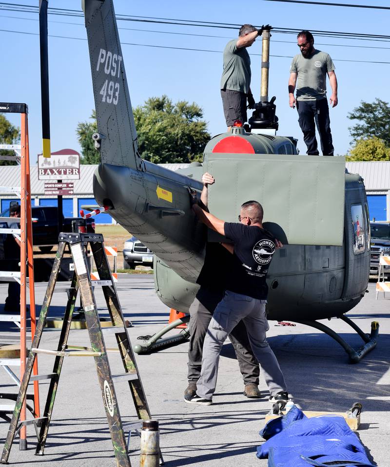 Crews from Midwest Aerospace prepare a Huey helicopter monument on Sept. 30 in Baxter.