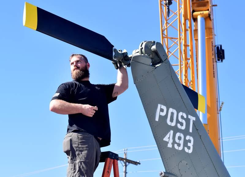JT Mullins of Midwest Aerospace connects the tail rotor to a Huey helicopter on Sept. 30 in Baxter.