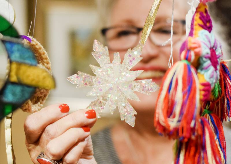 Terri Ayres, volunteer manager of the Geisler-Penquite Gift Shop at the Center for Arts & Artists, showcases the many handmade and donated items for sale at the store, the proceeds of which benefit creative-based programming and projects for youth.