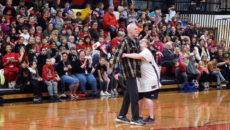 Amanda Church embraces a loved one during half-time of The Big Game on April 19 at Newton High School.