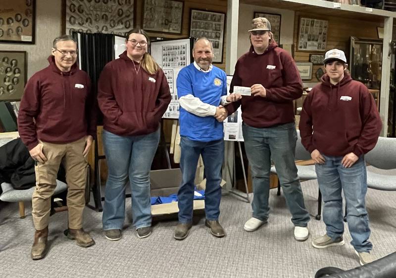 Lions Club President Greg Townley presents a $661.17 check to PCM Shooters Club representatives (from left): Coach Dusten Engel, Isabelle Lusk, president Greg Townley, Jonathon Swan and Levi Stevenson.