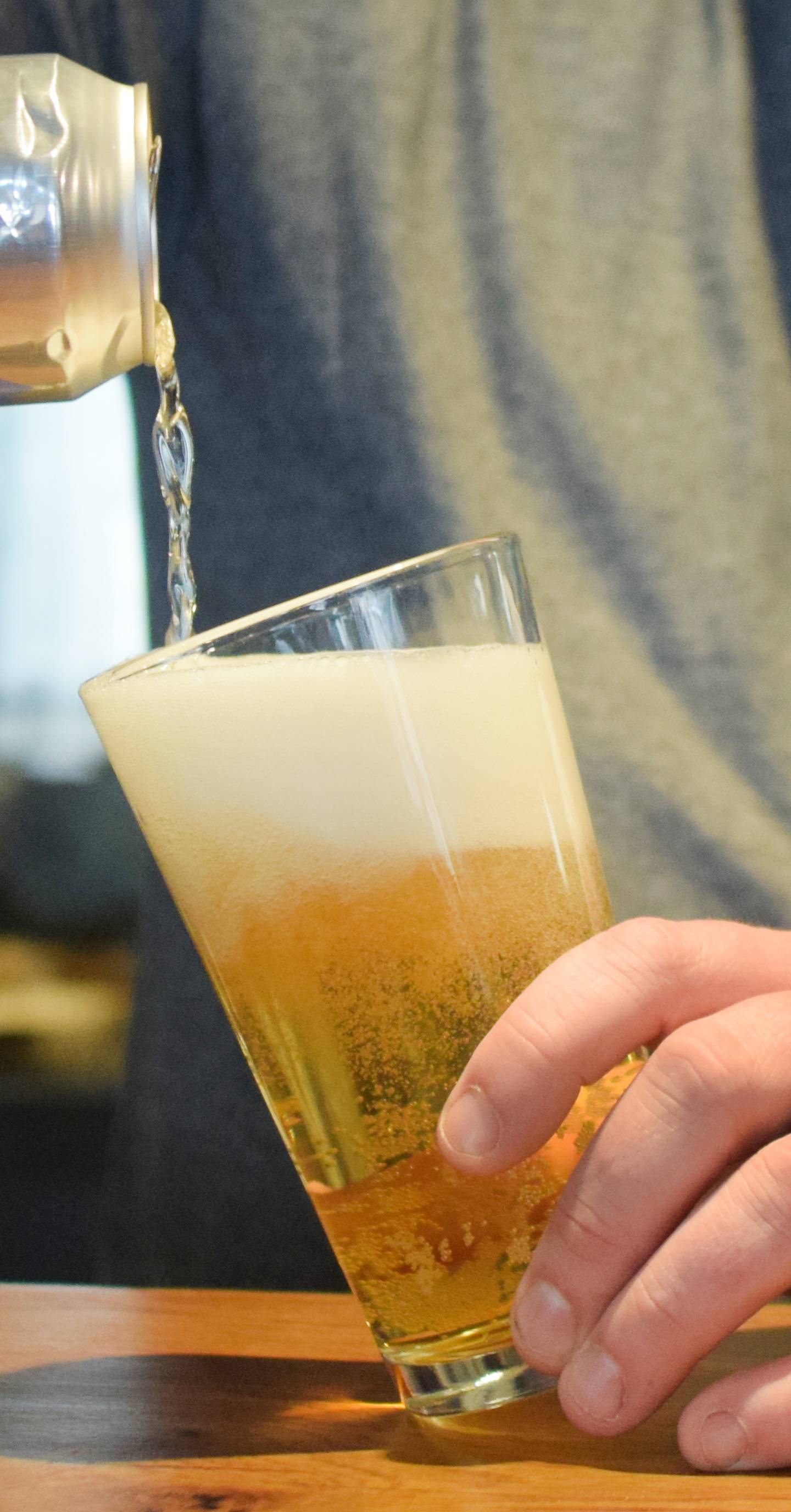 Conor Fudge, owner of Murph & Mary's Pub, pours a beer inside the new bar opening at Legacy Plaza this month. The pub's name and decor is inspired by his grandparents, Dick and Mary Agnes Murphy, who are longtime Newton residents and whose parents were Irish immigrants.