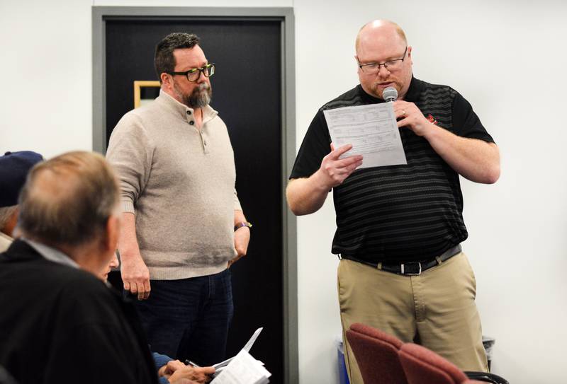 From left: School board member Travis Padget and NCSD Director of Business Services Tim Bloom speak with residents during a public hearing for the proposed tax levy on March 24 at the E.J.H. Beard Administration Center in Newton.