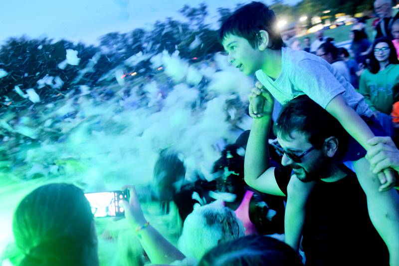 Kids participate in Driving Cap Entertainment's UV Glow Foam Party during Newton Fest on June 9 in Maytag Park in Newton.
