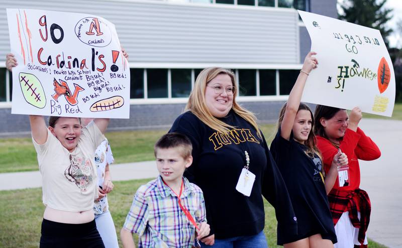 Students wearing Cyclone and Hawkeye apparel pose for pictures on Sept. 4 outside Berg Middle School. The whole study body was invited to welcome RVTV to town.
