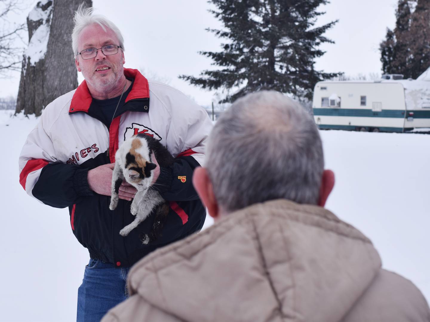 Bruce Doland's neighbor brings him a pet cat that was rescued from the home that caught fire Jan. 11 near the 1600 block of East Seventh Street South.