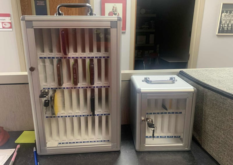The lockbox in Newton High School holds cellphones that have been confiscated from students who violated the district's policy. The school district has effectively banned cellphones in schools, and new legislation is forcing teachers and staff to be vigilant when enforcing the ban.