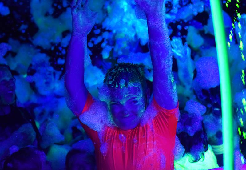 Kids enjoy the return of the Glow Foam Party – which featured two cannons this year – during Newton Fest on June 7 at Maytag Park.