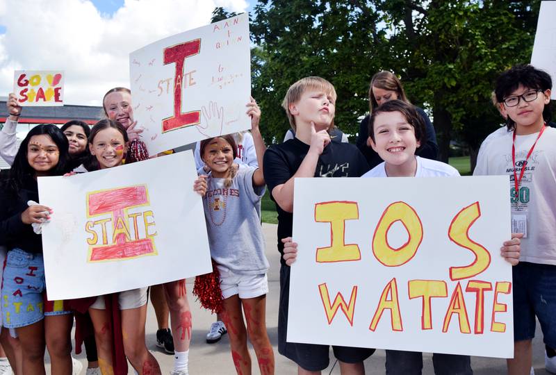 Students wearing Cyclone and Hawkeye apparel pose for pictures on Sept. 4 outside Berg Middle School. The whole study body was invited to welcome RVTV to town.