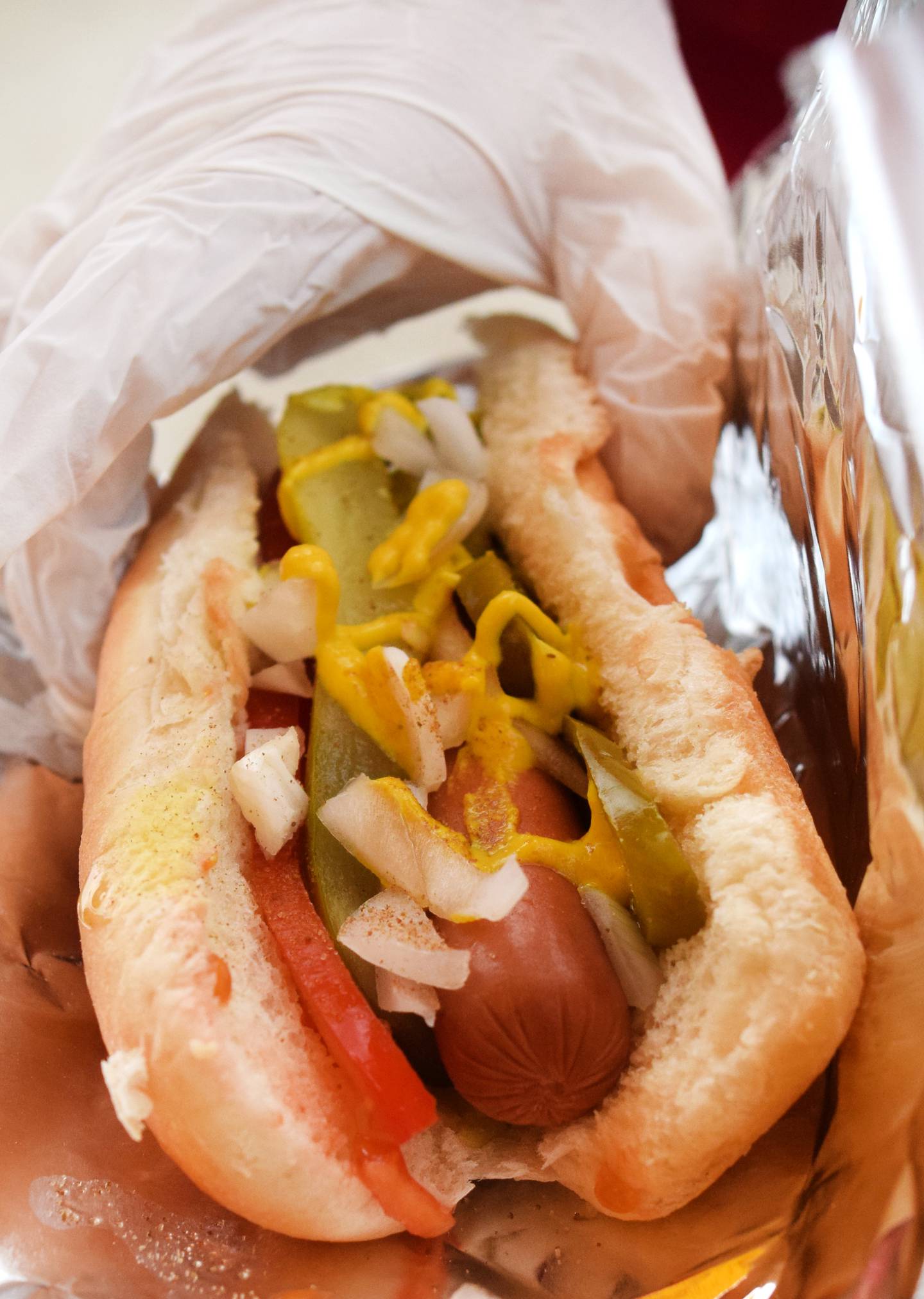 Harrison Miller, 12, prepares a Chicago-style hot dog on July 7 at Heavenly Hot Dogs, a hot dog cart just outside of Integrity Cleaning & Restoration in Newton.