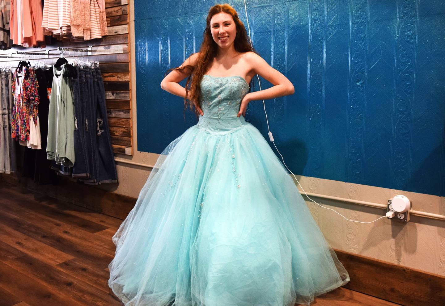 Cassidy Thompson, 16, of Albia High School showcases her new dress she picked out at the free giveaway event March 16 at Daughters Boutique Color Bar & Beauty Salon in Newton. Almost 200 dresses were up for grabs at the event this past weekend.