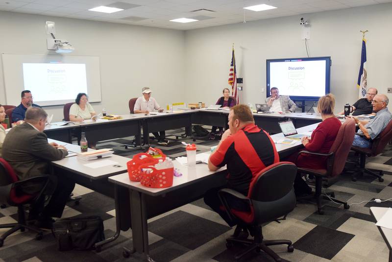Newton school board members discuss the configuration options which now include a west side option, but data shows it may not be the most economical choice.