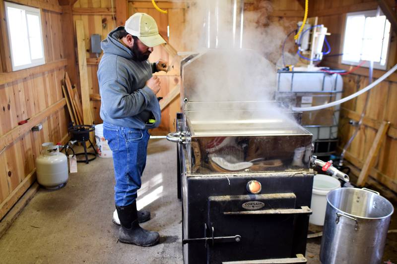 Greg Oldsen, a naturalist for Jasper County Conservation, attends to the syrup system inside the Sugar Shack at Jacob Krumm Nature Preserve. Conservation acquired a new reverse osmosis unit that has increased efficiencies when making syrup, along with staff's suction tubing collection system that can quickly extract sap from sugar maple trees.