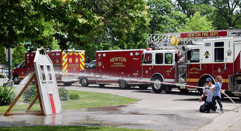 Kids participate in obstacle courses and take a try at the fire hose during Safety Fest on June 8 in Maytag Park. Safety Fest is regularly organized by the Newton Fire Department.