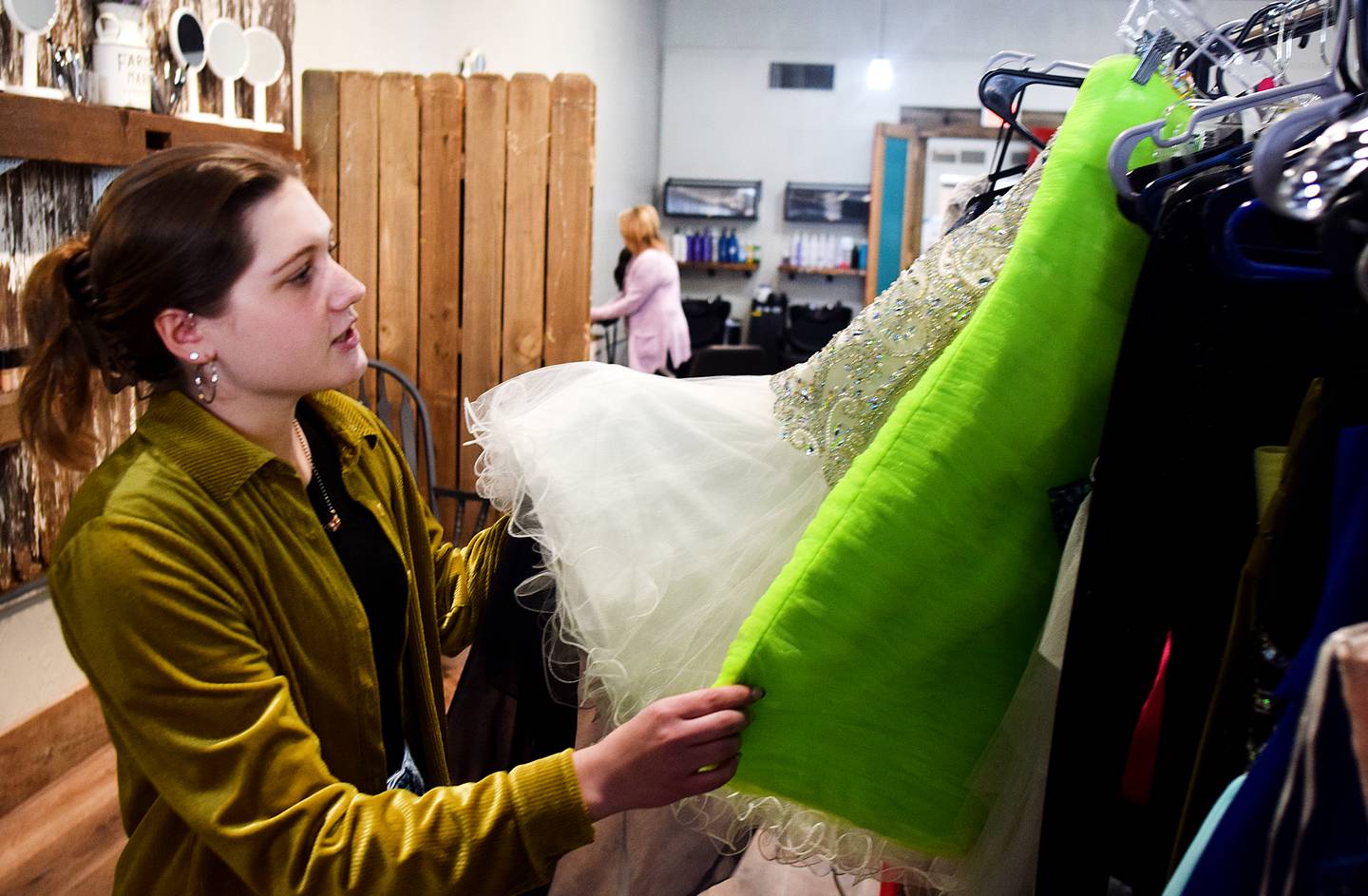 Lydia Schwaller, 17, of Grand View Christian School, showcases some of the nearly 200 dresses she has collected over the years and were up for grabs during a prom dress giveaway event March 16 at Daughters Boutique Color Bar & Beauty Salon in Newton.