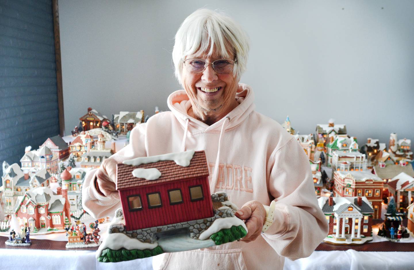 Sandi Rodgers, of rural Newton, showcases her collection of "holiday houses" that she has received from her son every Christmas since he was 8 or 9 years old. Her son, Joe, is now 45 years old. Rodgers says she has about 50 buildings in her collection, and she arranges them like a town with the help of her grandchildren.