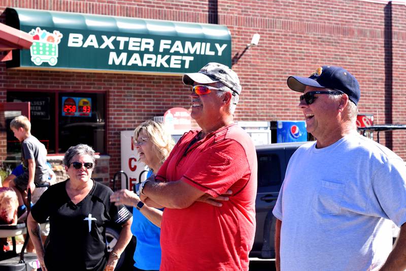Residents watch the progress of the Huey helicopter memorial installation on Sept. 30 in Baxter.