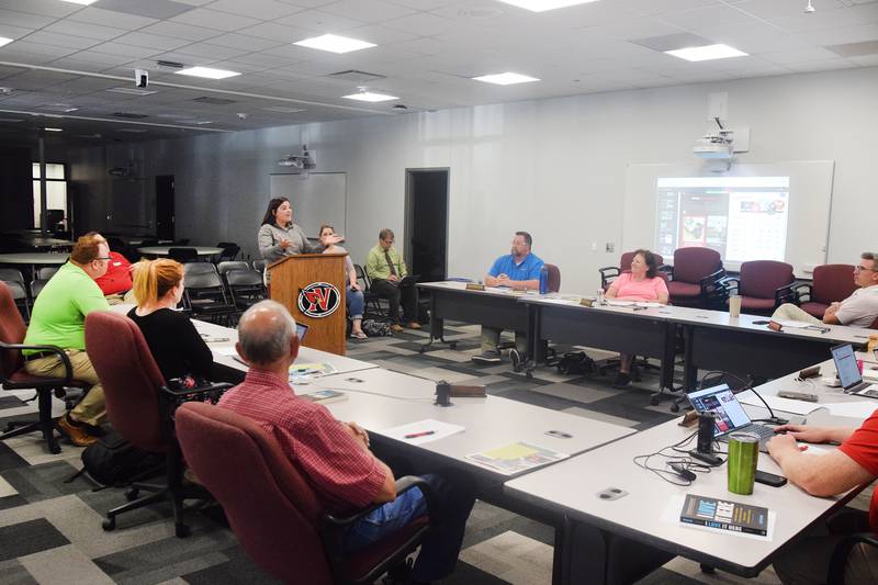 Jordan Bell, a member School Improvement Advisory Committee, speaks with school board members on Aug. 22 at the E.J.H. Beard Administration Center in Newton.