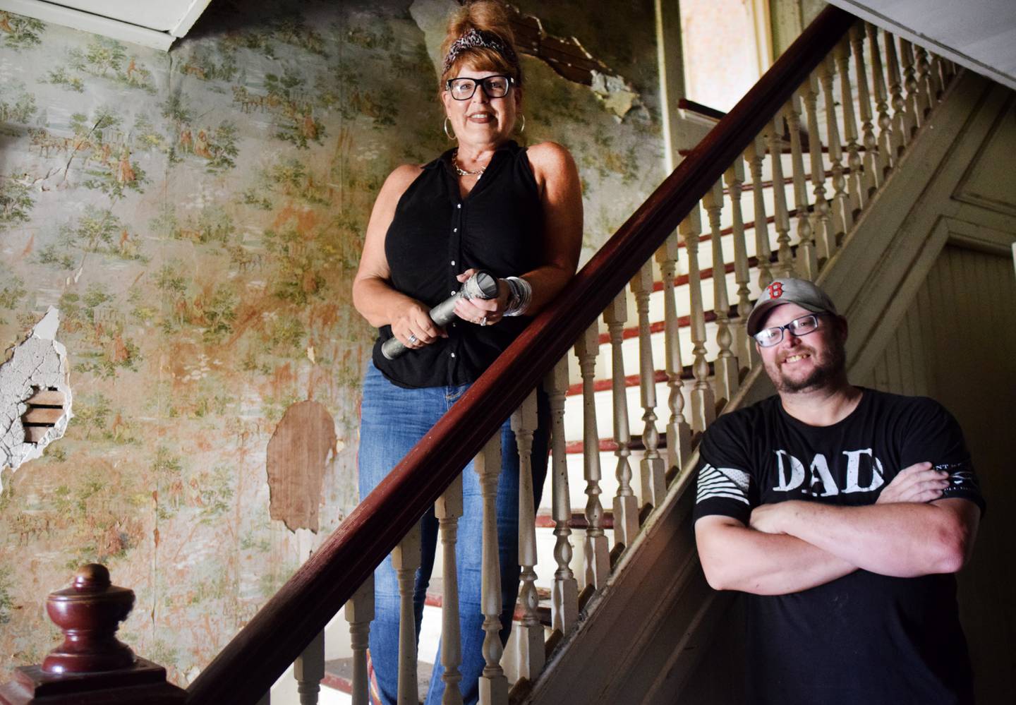 Nancy Sorbella of Carmel, N.Y., and Roger Seiser of Newton stand by the stairwell of a 112-year-old property at 427 N. Third Ave. E. in Newton. Sorbella says she has become obsessed with the home, which belonged to her family at one point, and she wants to restore it back to life.