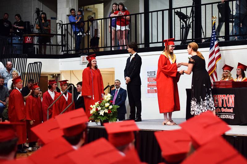 The Newton High School Class of 2024 seniors walk the stage during commencement on May 19 inside the high school gymnasium.