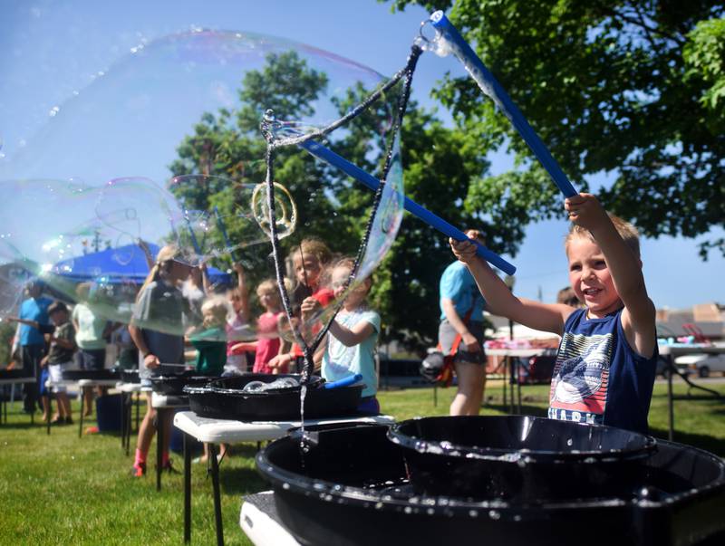 Lots of children participate in the Absolute Science Bubble Open House on June 20 at the Newton Public Library.