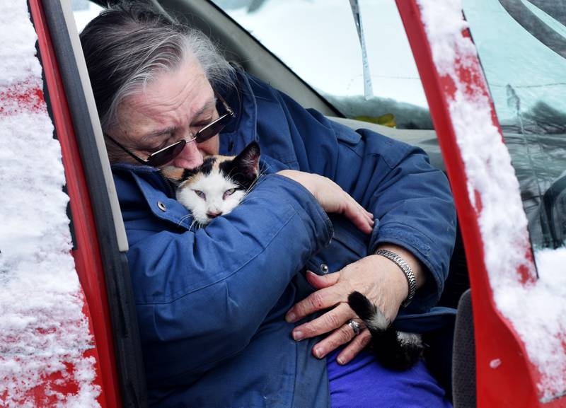 Cynda Doland of Newton embraces her cat, Babydoll, who was rescued from her home that caught fire Jan. 11 near the 1600 block of East Seventh Street South.