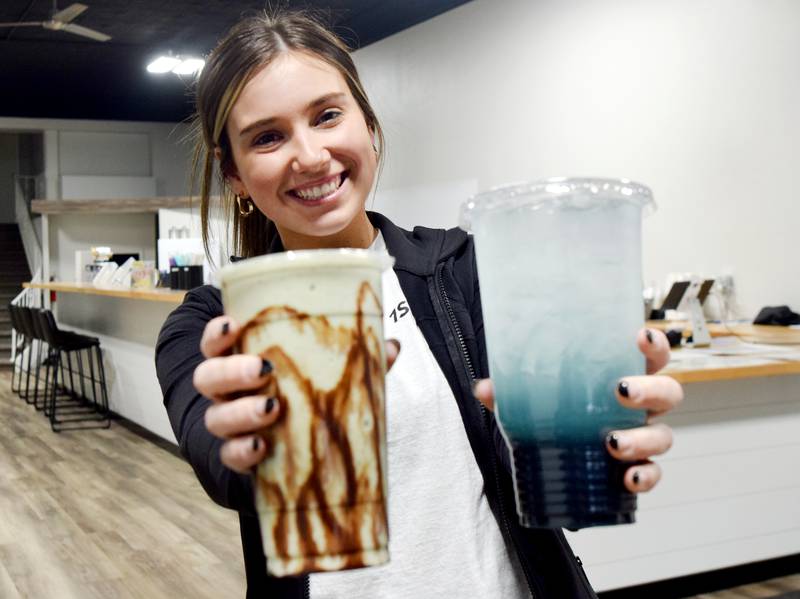 Darian Morrison, of Newton, showcases a shake and a team from 1st Ave Nutrition. At 19 years old, Morrison is considered to be the youngest brick-and-mortar business owner in Newton.