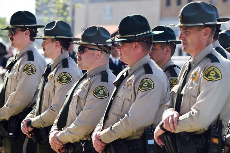 Officials from the Jasper County Sheriff's Office stand at attention during the National Police Week ceremony May 12 at the Jasper County Courthouse.