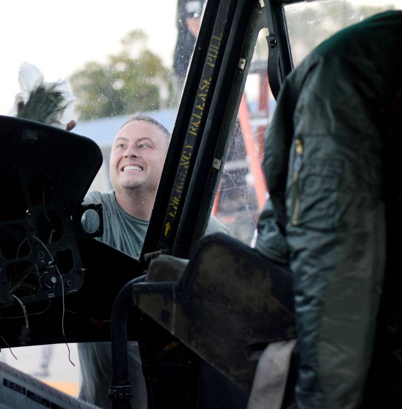 Joe Giannini of Midwest Aerospace wipes down a Huey helicopter on Sept. 30 in Baxter.