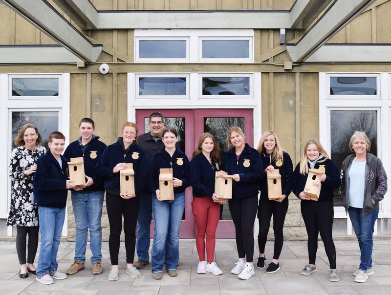 Middle school students of the Newton FFA group — from left: Carter Lehrman, Ben Leonard, Ashlyn VanManen, Grace Guy, Mackenzie Cupples, Rilyn Titus, Aliviah Ross, and Brilea Moffitt — showcase their handmade bluebird birdhouses, which will eventually be installed on a "bluebird trail" at the Newton Arboretum and Botanical Gardens.