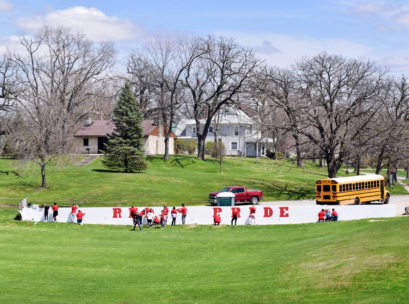 Students paint a mural during Red Pride Service Day on May 4 at Sunset Park in Newton. Park board members took a survey ranking their priority amenities for the Sunset Park concept plan. Many of the top of priorities, like walking trails, would improve accessibility.