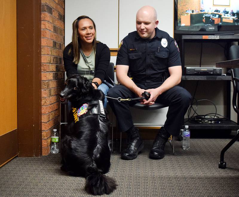 K9 Smokey and his handler, officer Zach Walker, wait for a presentation honoring Smokey's retirement from the Newton Police Department during the June 6 city council meeting.