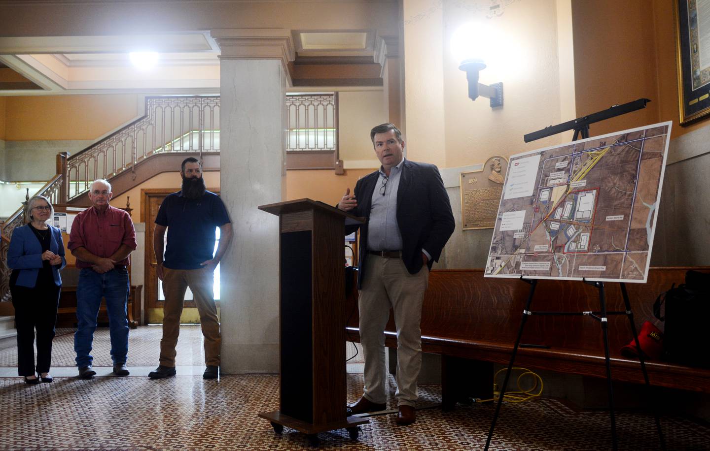 Joe Parsons, president and CEO of Iowa Interstate Railroad, LLC, speaks to community members on July 30 at the rotunda of the Jasper County Courthouse to celebrate the finalized joint land purchase that will host a rail park northeast of Newton.