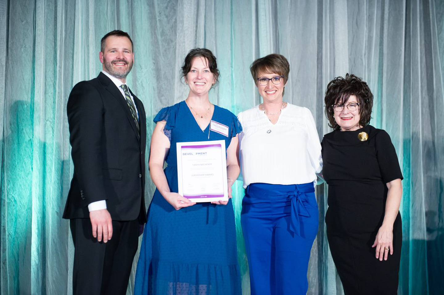 From left: Michael Wagler, Main Street Iowa state coordinator; Tanya Michener, past board president of Newton Main Street; Erin Yeager, executive director of Newton Main Street; and Debi Durham, executive director of the Iowa Economic Development Authority (IEDA) and Iowa Finance Authority (IFA), pose for a photo during the Main Street Iowa Development Awards on April 21 in Des Moines. Michener was awarded for her leadership.