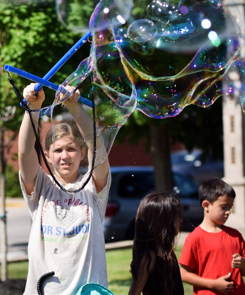 Lots of children participate in the Absolute Science Bubble Open House on June 20 at the Newton Public Library.