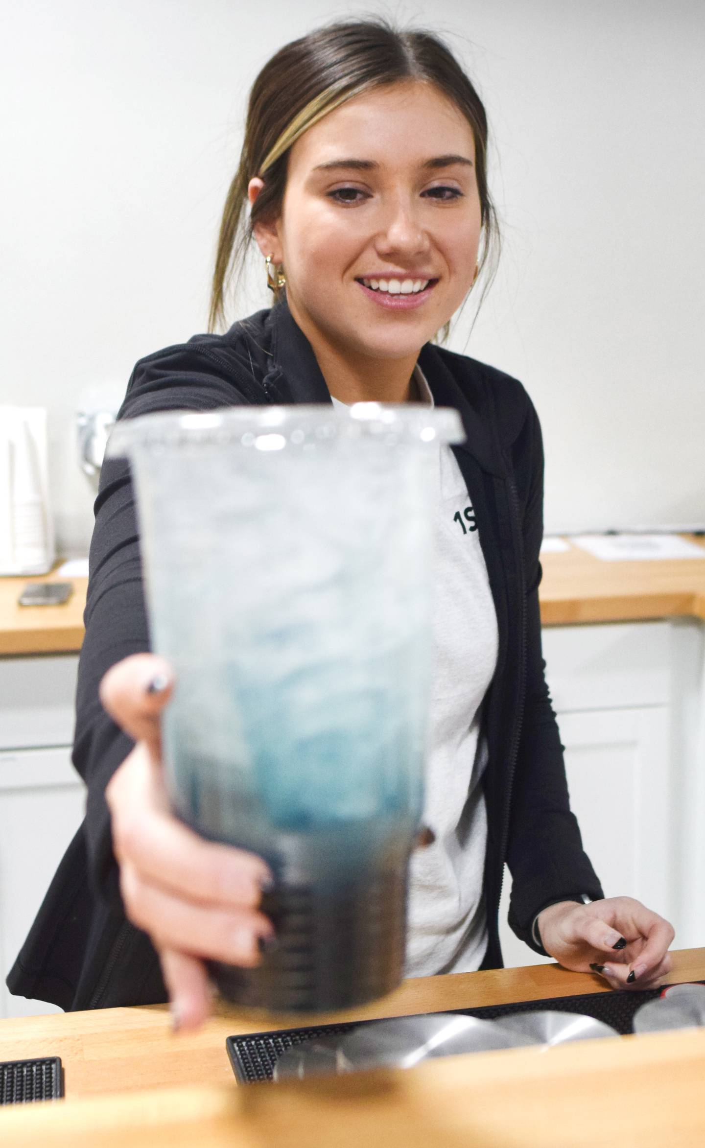 Darian Morrison, of Newton, serves a energized tea at 1st Ave Nutrition. At 19 years old, Morrison is considered to be the youngest brick-and-mortar business owner in Newton.