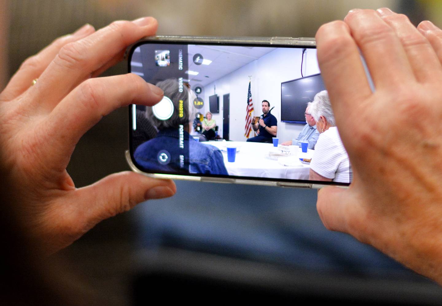 A guest takes a picture of Iowa House Rep. Josh Turek, who is running for U.S. Senate, during the Jasper County Democrats Soup Supper on Oct. 5 at the E.J.H. Beard Administration Center in Newton.