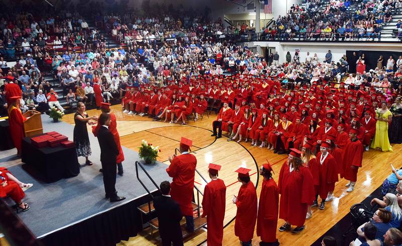 The Newton High School Class of 2024 seniors walk the stage during commencement on May 19 inside the high school gymnasium.