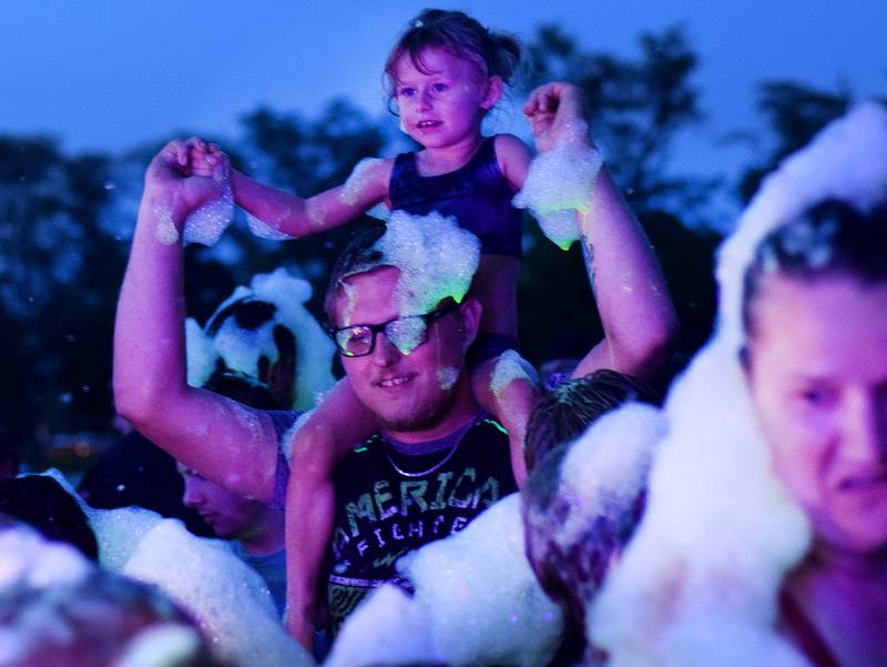 Kids participate in Driving Cap Entertainment's UV Glow Foam Party during Newton Fest on June 9 in Maytag Park in Newton.